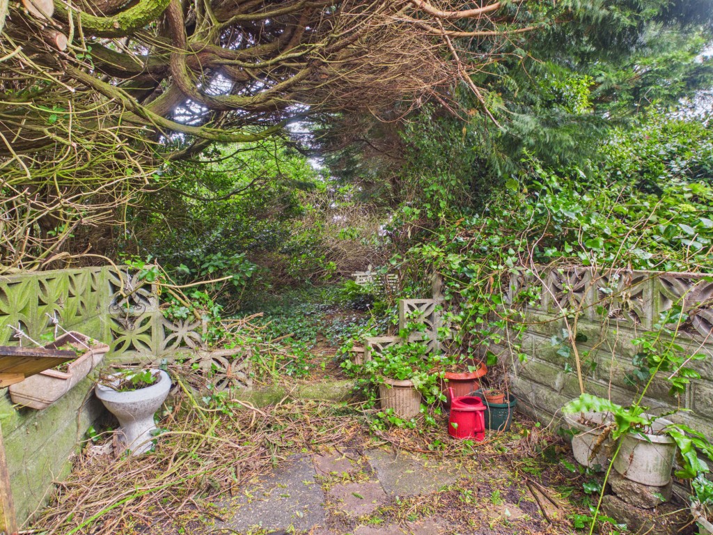Lot: 102 - LINK-DETACHED TWO-BEDROOM BUNGALOW FOR UPDATING - Rear patio area leading to overgrown garden